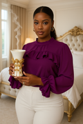 Elegant incense burner held by a woman in a purple blouse, with smoke rising, set in a stylish interior.